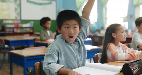 School, student and boy with answer, desk and learning in class, excited and question for studying