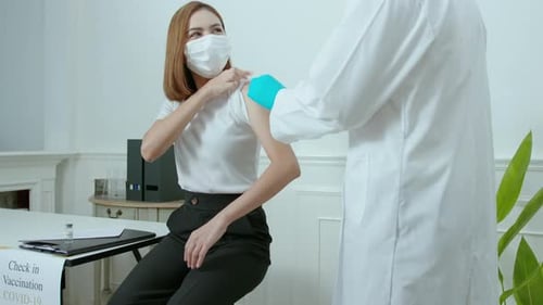 Adult Woman Receiving Vaccine from Medical Professional