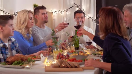 Family at Festive Dinner Table with Wine Glasses