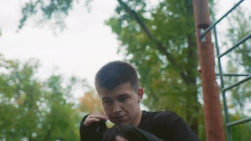 Athletic Man Shadow Boxing Outdoors in City Park