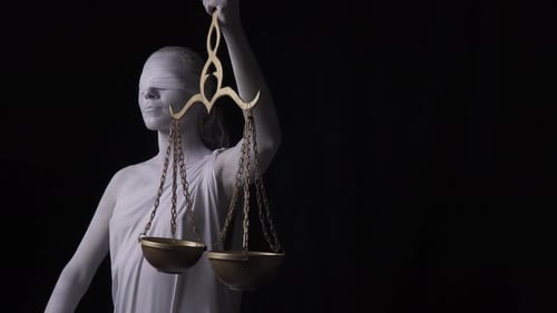 Human statue of Themis with the golden scales, on dark background, 4k