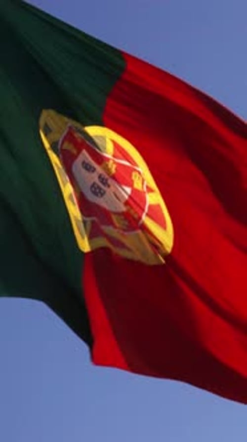 Portuguese Flag Waving Against a Blue Sky