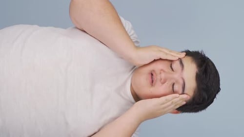 Young Man Massaging Temples with a Headache