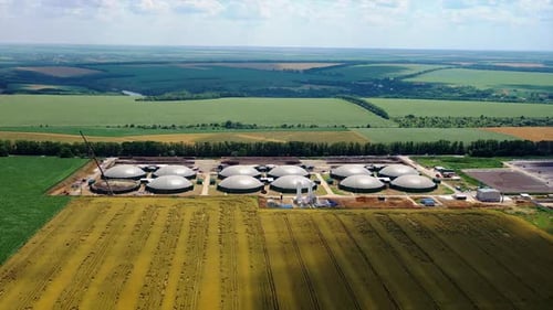 Large gas storage on the field. Factory and power plant with many storage tanks