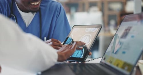 Doctors Reviewing Brain Scans on a Tablet Device