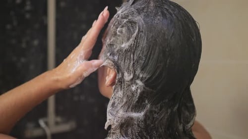 Woman Shampooing Her Hair in Shower