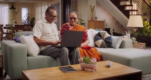 Senior Couple Using Laptop Computer in Home