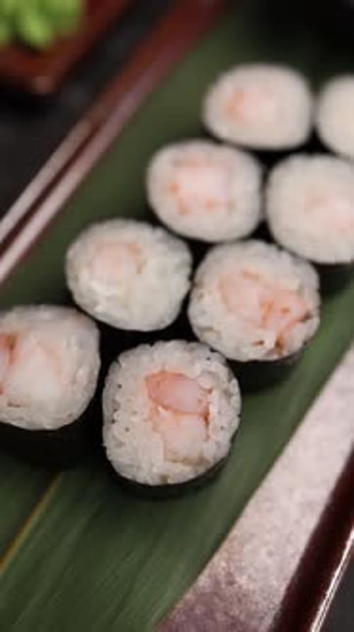 Close-up of delicious Japanese sushi rolls served fresh on a plate in a restaurant.