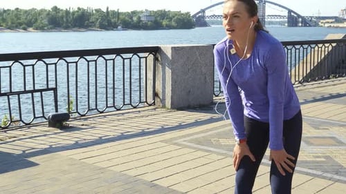 Young Woman Sprints Into View and Pauses to Catch Her Breath