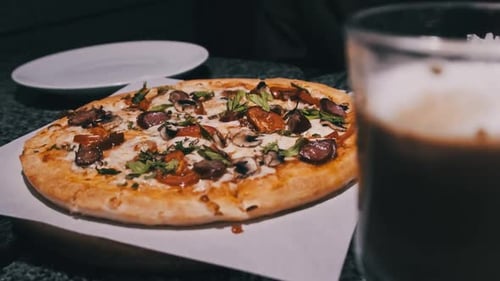 Fresh Pizza on the Table in the Restaurant