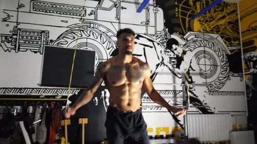 Muscular Afro American Sportsman Skipping with a Jump Rope at Sport Club Strong African Athlete with