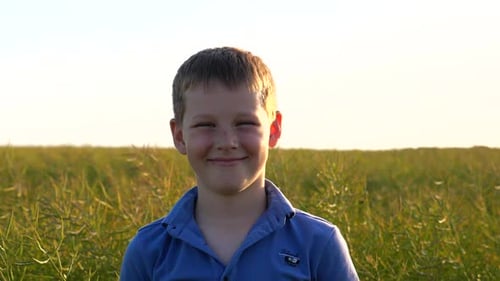 Portrait of Cute Small Child Looking Into Camera and Smiling