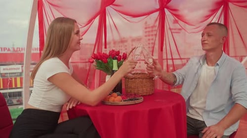 Romantic Couple Toasting Champagne on Rooftop Date