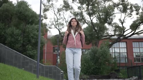 Young Student Walking on Campus Pathway Enjoying University Life