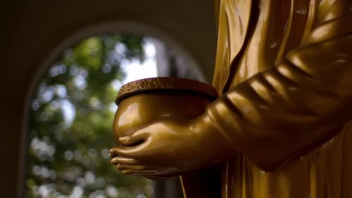 Hand Of Golden Buddha Holding Bowl At Buu Long Pagoda In Ho Chi Minh City, Vietnam. - closeup shot
