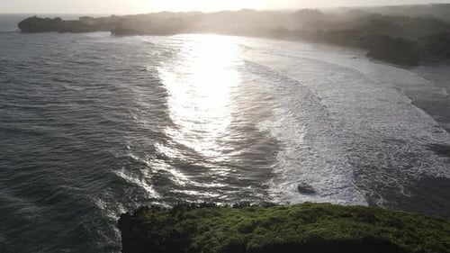 Aerial view of beautiful sunset at Beach in Indonesia with yellow sunny day.