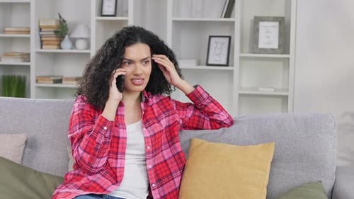 Young Woman Chatting on Phone in Living Room