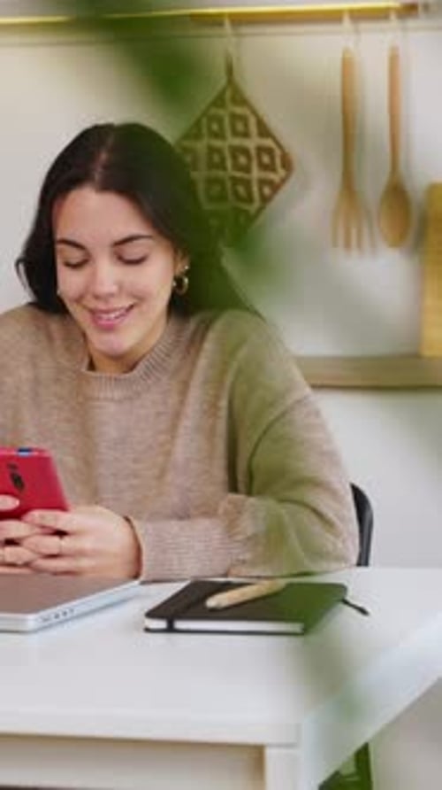 Smiling Woman Using Mobile Phone at Home