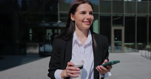 Business Woman Walking on City Street Using Phone