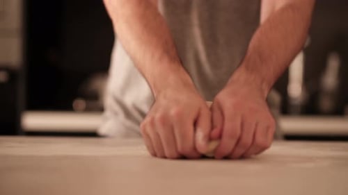 Hands Kneading Fresh Dough in Kitchen