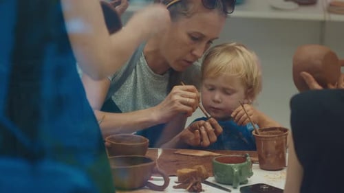 Mother with Kids Learn Pottery and Shape the Clay in the Pottery Studio During Pottery Masterclass