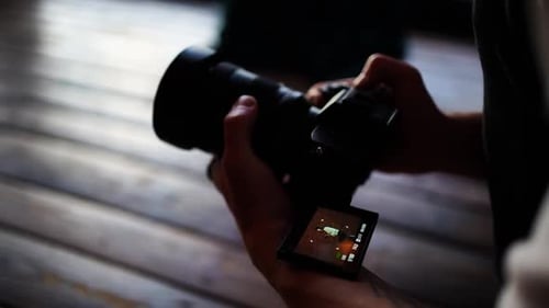 Close-Up of Man Holding Digital Camera