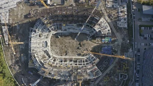 Aerial view of a construction site of a multi storey house. Stock footage. Concept of urbanization.