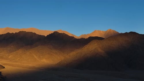 Aerial Drone shot of beautiful orange mountains in sunset in ladakh