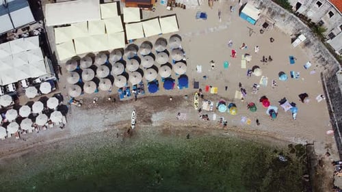 Aerial view of the seaside umbrellas and people
