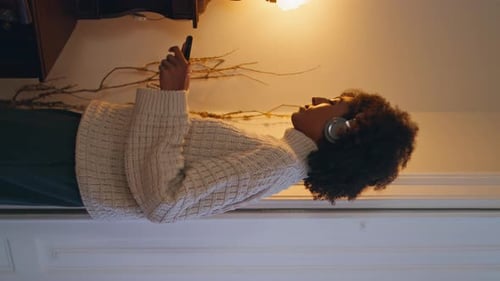 Carefree Lady Dancing at Home Headphones Woman Listening Music Vertically Shot