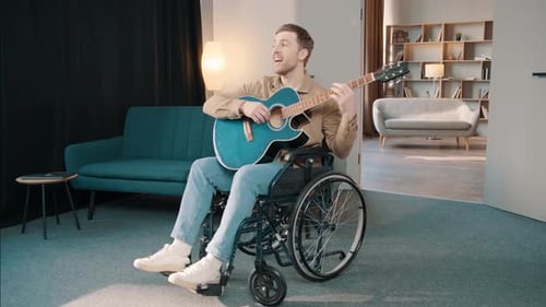 Man in Wheelchair Plays Acoustic Guitar