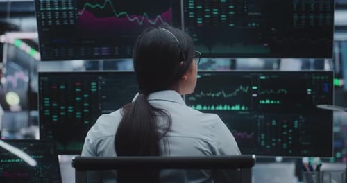 Young Woman Expert Analyzes Market Trends on High Tech Monitors in Massive Digital Office