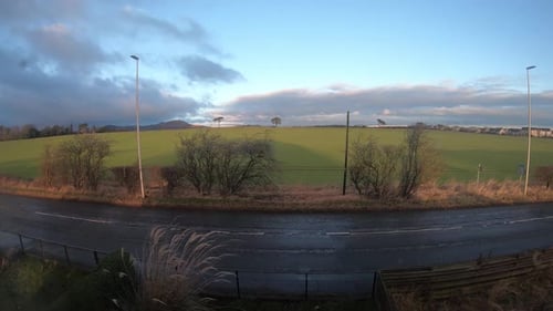Timelapse of busy countryside road as clouds move above