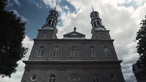 Front View of The Old Parish Of Saint-Eustache Against The Blue Sky With Fluffy White Clouds In Sain