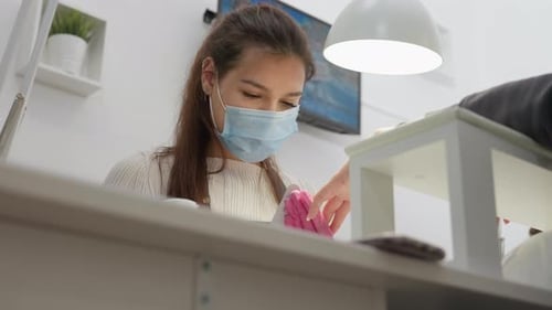 Manicurist Working on Client's Nails in Salon