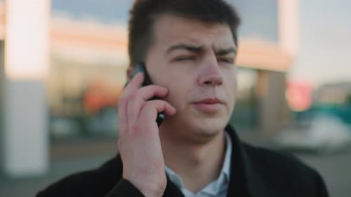 Young Adult Talking on Phone in City Close Up