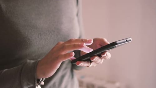 Adult Using Cell Phone Indoors Close Up