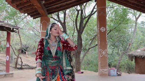 Women Dancing in Traditional Clothing in Rural Setting