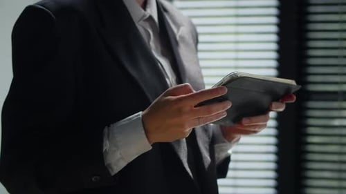 Closeup Shot of Business Woman in Suit Using Tablet in Office Building Architector Working on
