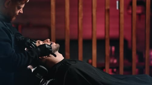 Barber Shaving Man's Beard with Straight Razor