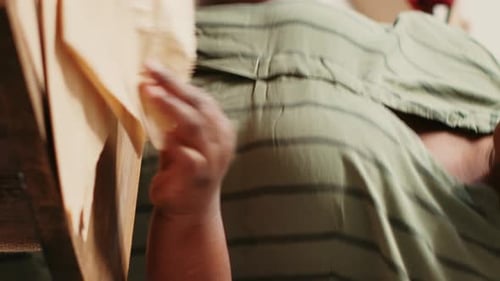 Woman Filling Paper Bag with Pasta at Home