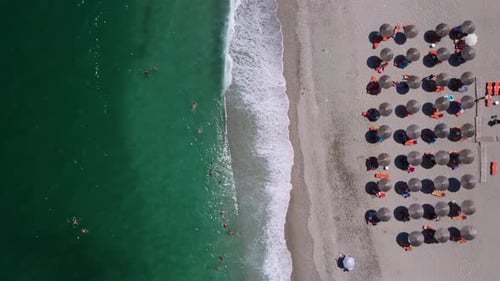 Top-down Aerial of Organized Beach with Umbrellas and Turquoise Water