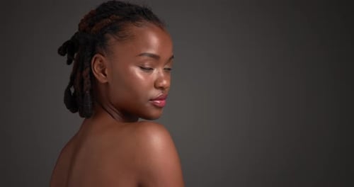 Shoulder, skincare and face of black woman in studio for beauty, body care and clear skin glow