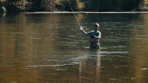 Fisherman Casts the Fly on a River