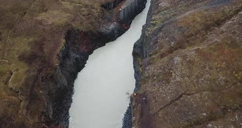 Birdseye Aerial View on Studlagil Canyon in Iceland Highlands. Glacier River Between Basalt Rock For