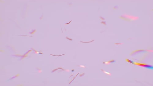 Falling Gold Confetti with soft focus rainbow color rays of light.