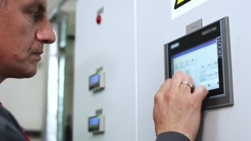 Factory Worker Touch Screen Display. Engineer Working with Industrial Computer Equipment. Industrial