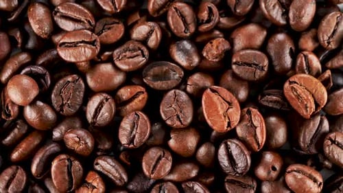 Extreme close up dark rich freshly roasted coffee bean texture