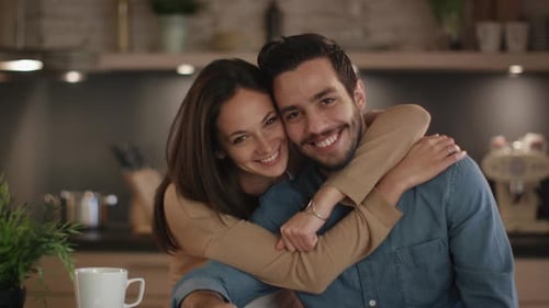 Affectionate Couple Embracing in a Modern Kitchen