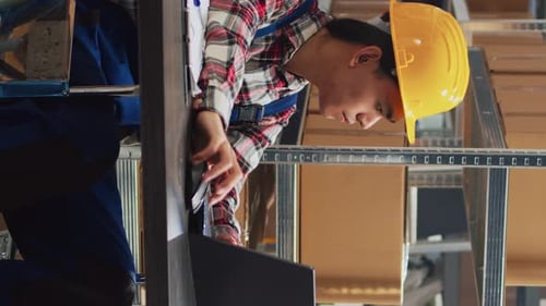 Young Adults Working with Laptop and Audio Device